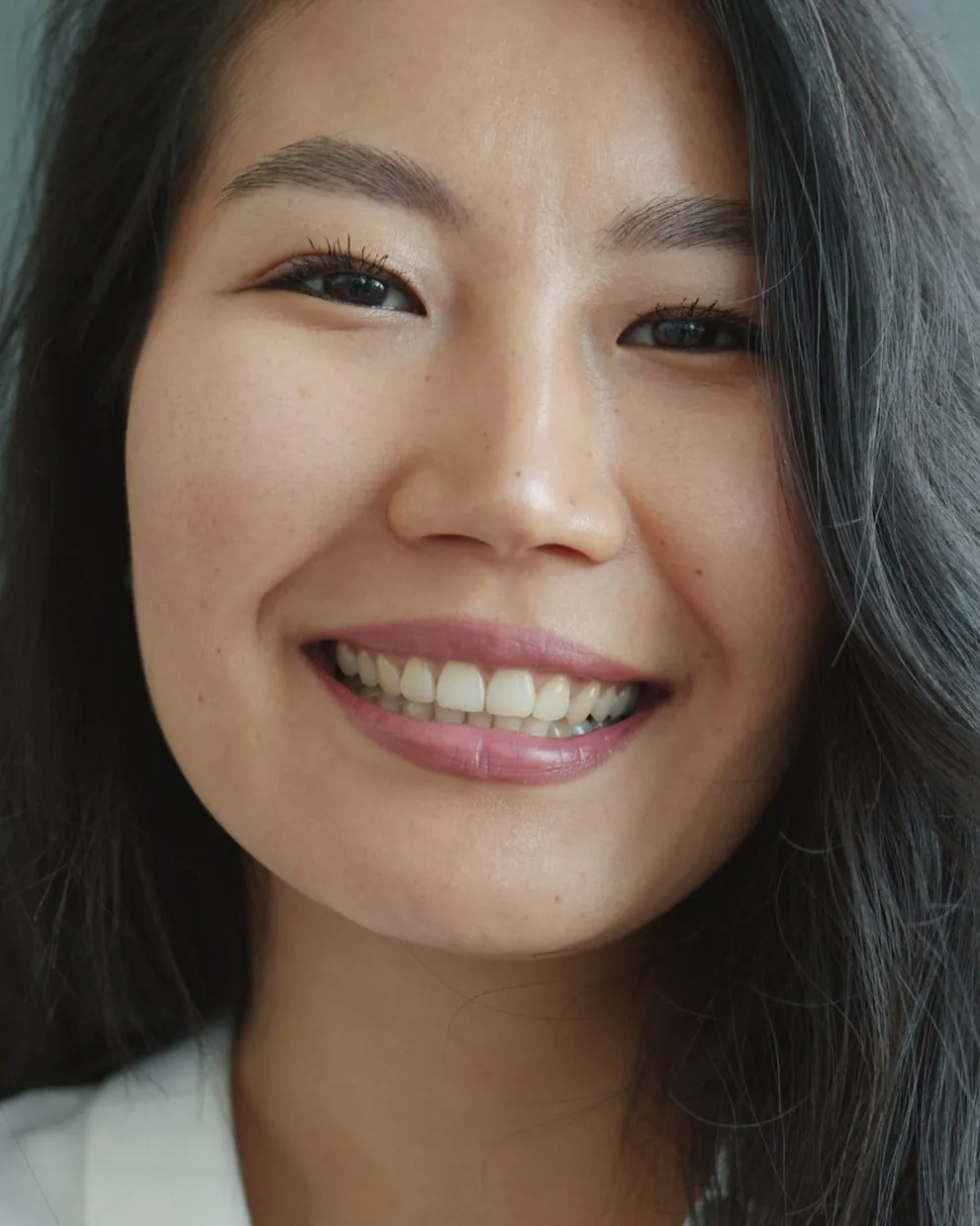 A smiling woman on a video consultation